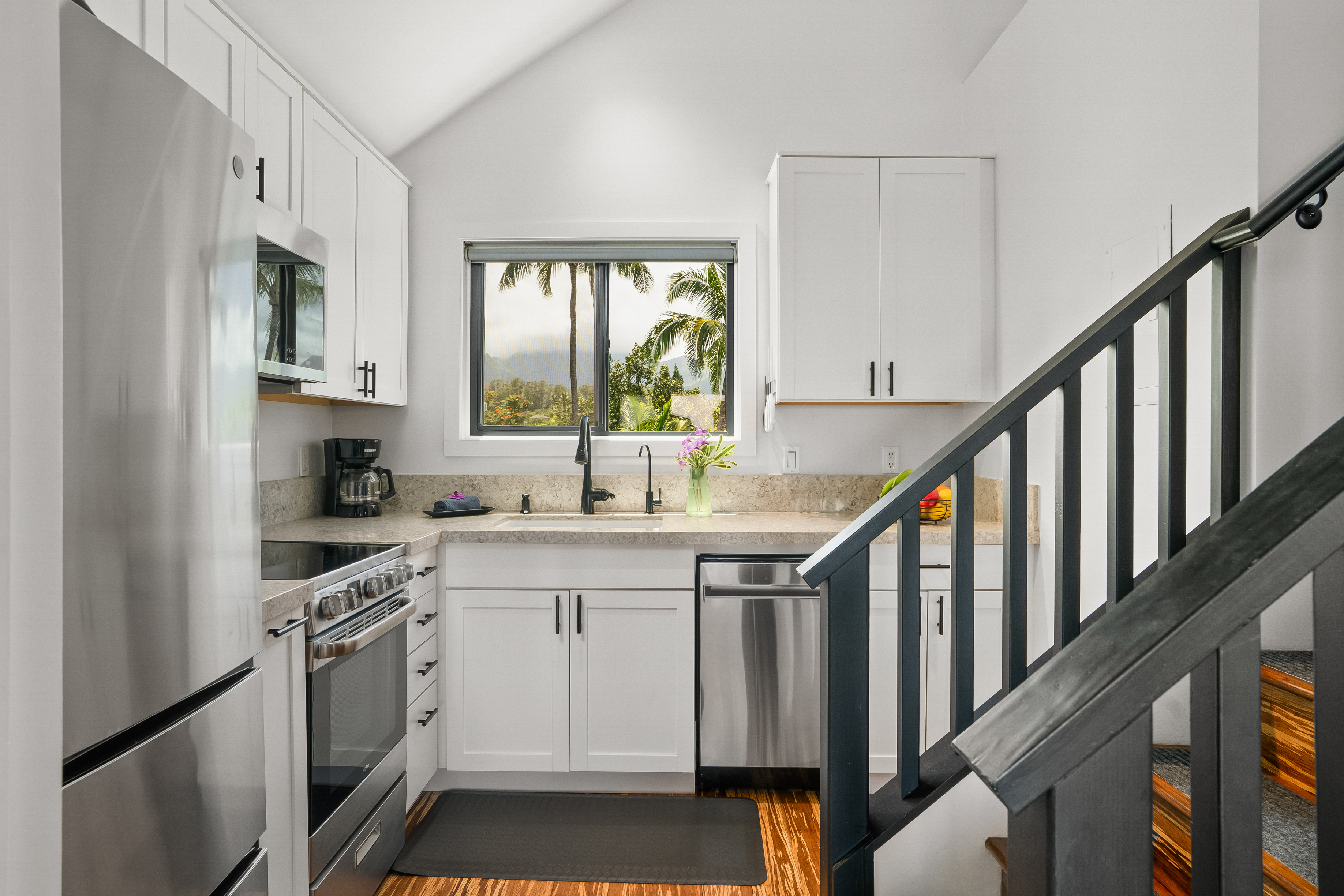 3700 Kamehameha Road, Unit F8 Princeville, HI 96722 - Photo 10 of 30 a kitchen with stainless steel appliances granite countertop a stove and a sink