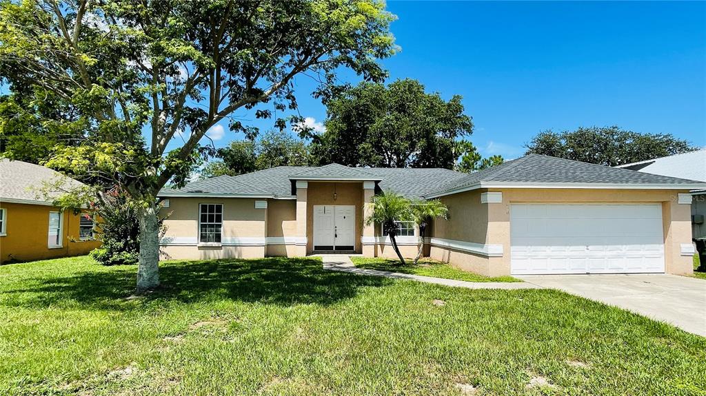 a front view of house with a garden