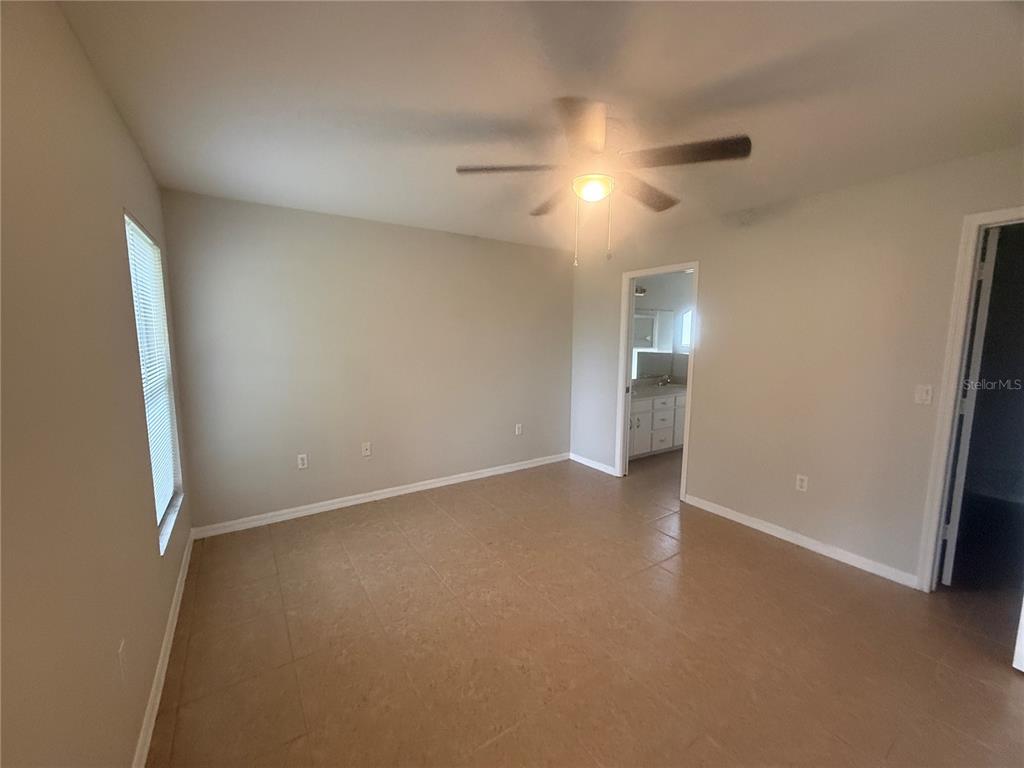 620 Reflections Loop West Winter Haven, FL 33884 - Photo 19 of 31 an empty room with an entryway and fan