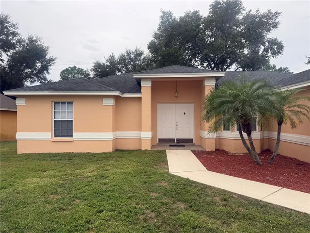 a front view of house with yard and trees