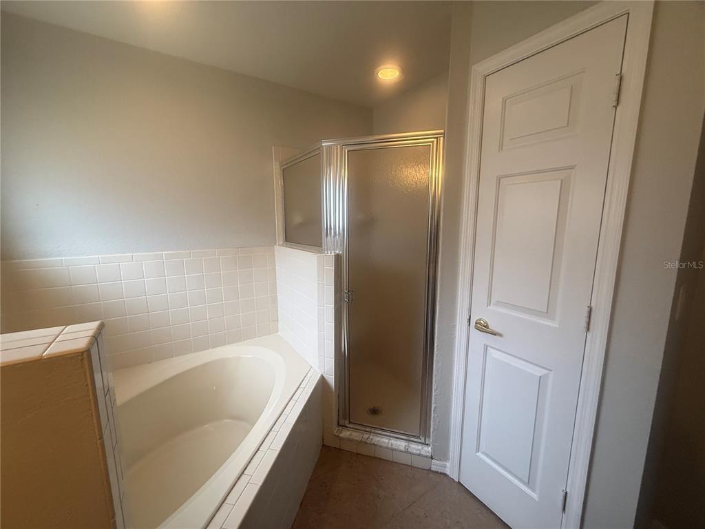 620 Reflections Loop West Winter Haven, FL 33884 - Photo 21 of 31 a bathroom with a bathtub and a shower
