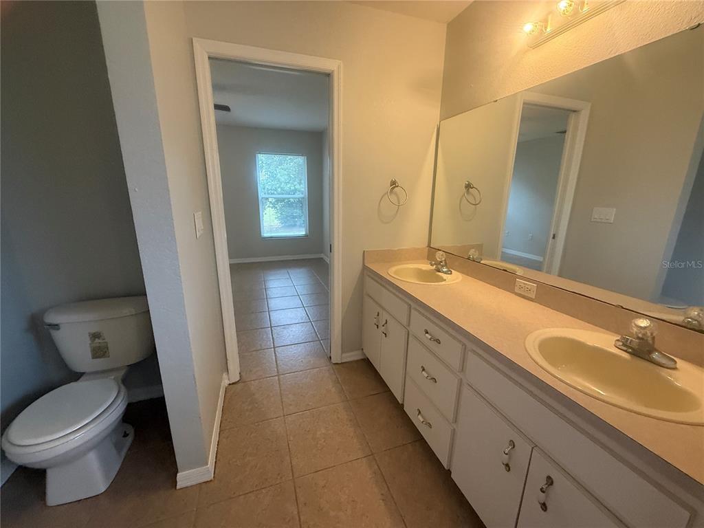 620 Reflections Loop West Winter Haven, FL 33884 - Photo 23 of 31 a spacious bathroom with a double vanity sink and a mirror
