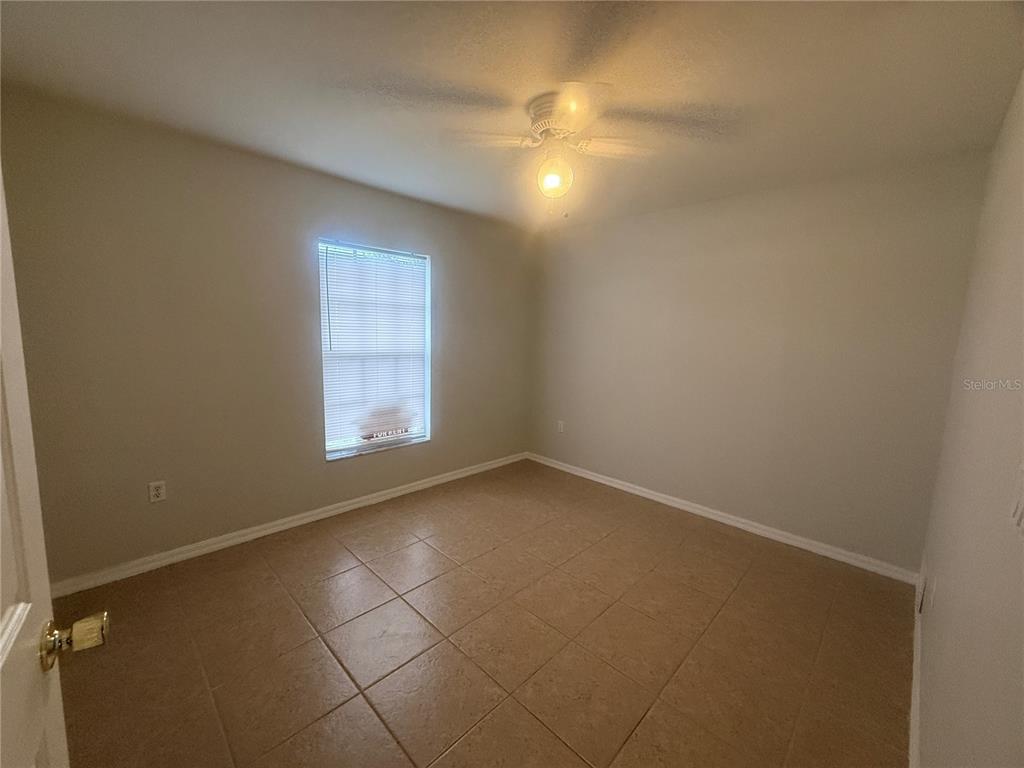 620 Reflections Loop West Winter Haven, FL 33884 - Photo 26 of 31 an empty room with windows and fan