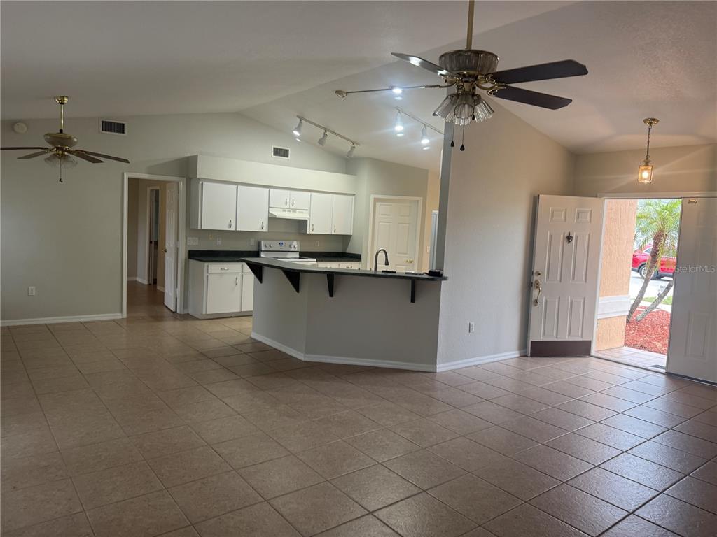 620 Reflections Loop West Winter Haven, FL 33884 - Photo 5 of 31 a kitchen with stainless steel appliances granite countertop a refrigerator and a sink