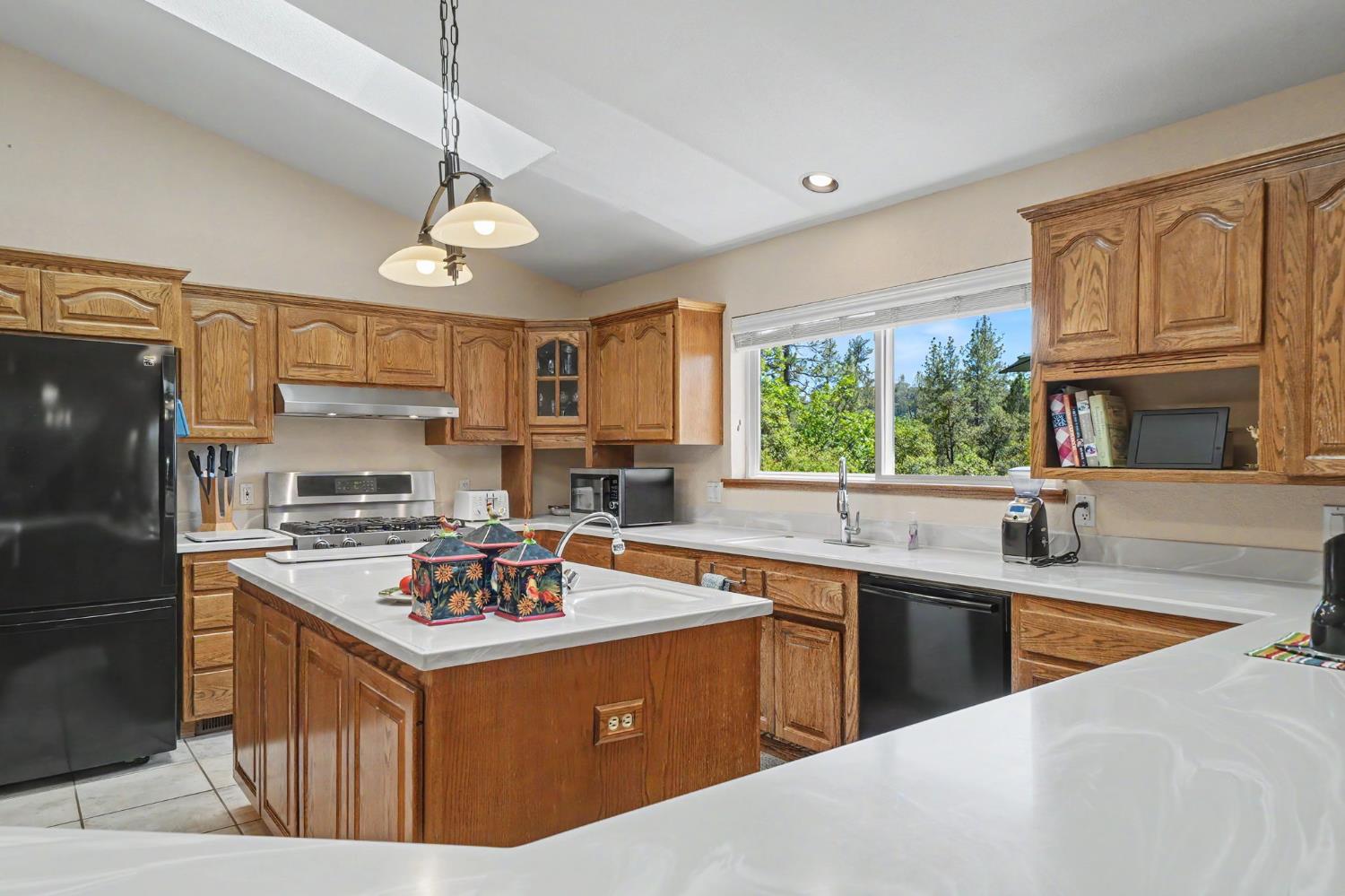 18299 West Clinton Road Jackson, CA 95642 - Photo 21 of 56 a kitchen with stainless steel appliances granite countertop a sink stove and refrigerator