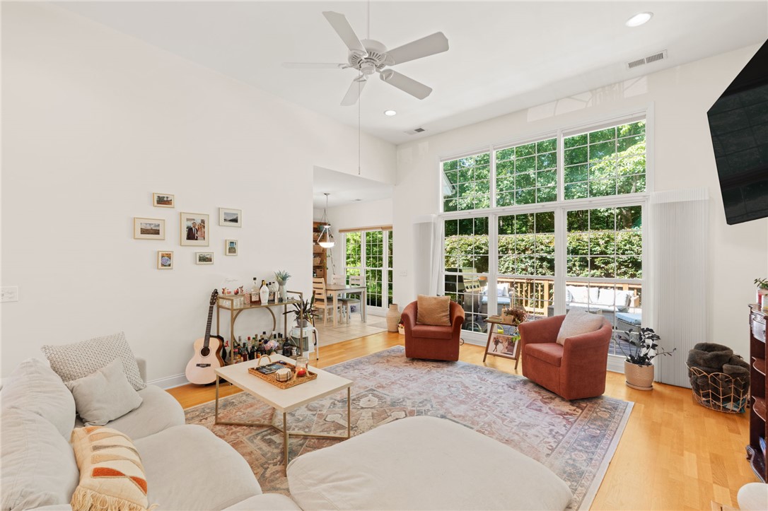 108 Winterbrook Circle Seneca, SC 29678 - Photo 11 of 40 A spacious living area features high ceilings and abundant natural light through large windows overlooking a peaceful deck.