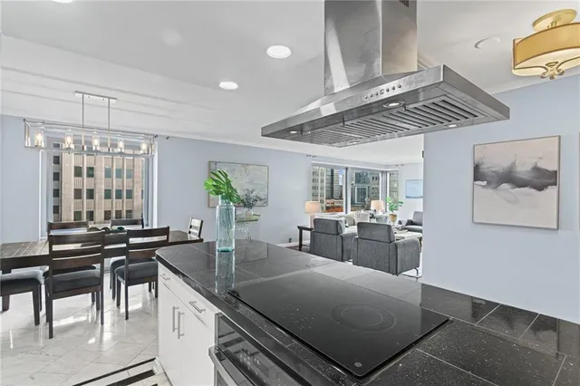 a kitchen with a table chairs and wooden floor