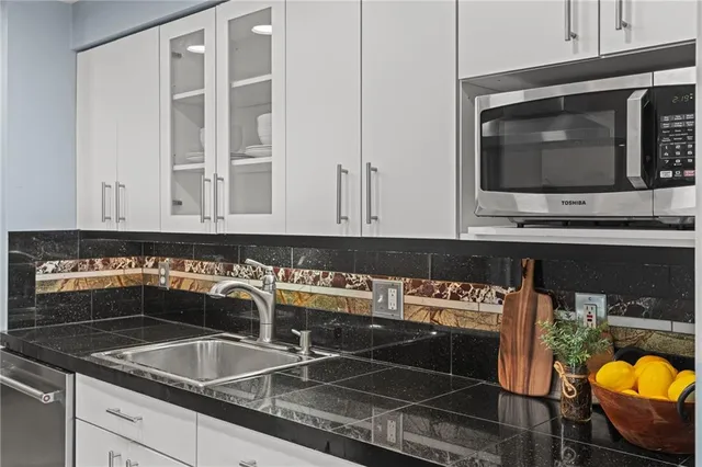 a kitchen with a sink and a stove next to a window