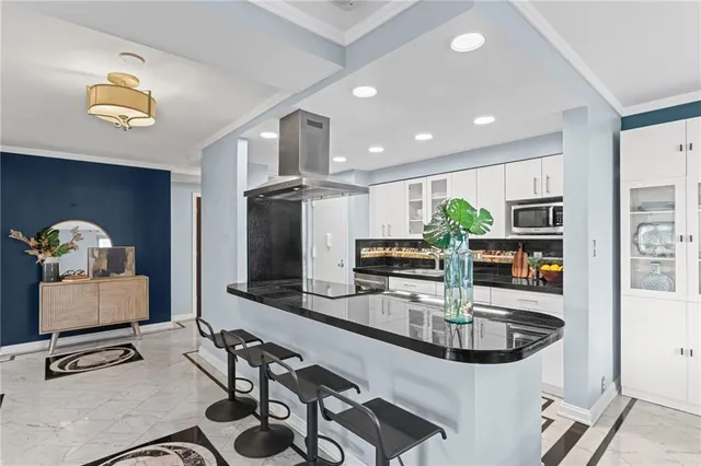 a kitchen with stainless steel appliances a sink a stove and cabinets