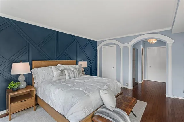 a bed room with a bed and a chair