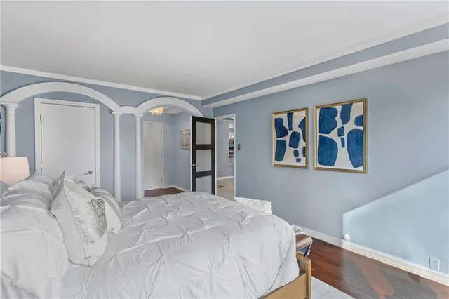 a bedroom with a large bed and a window