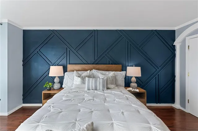 a bed room with a bed and a chair