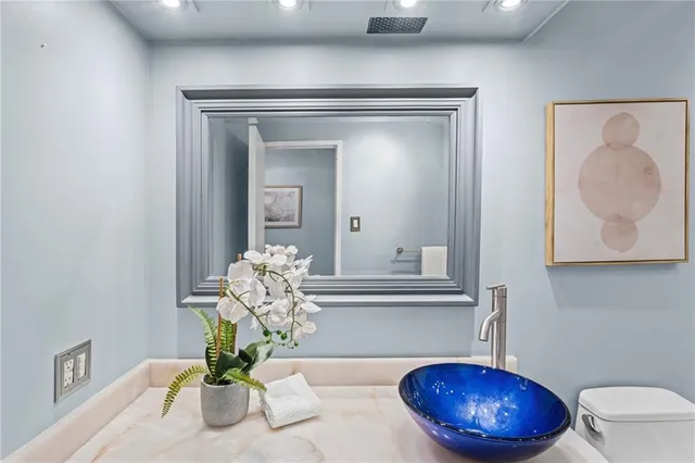 a view of bathroom with a potted plant and a wooden table