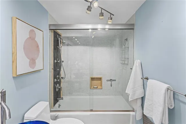 a bathroom with a tub and a shower