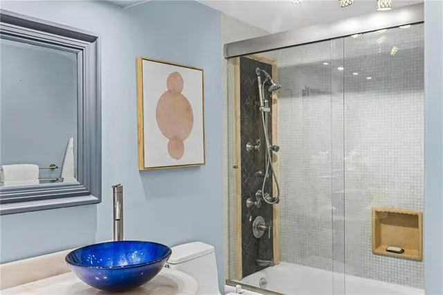 a bathroom with a toilet and a mirror