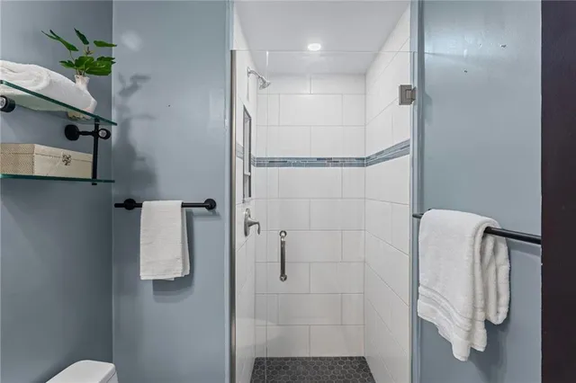 a bathroom with a shower and a sink