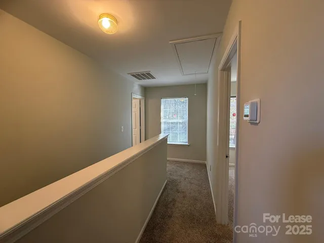 a view of hallway with windows