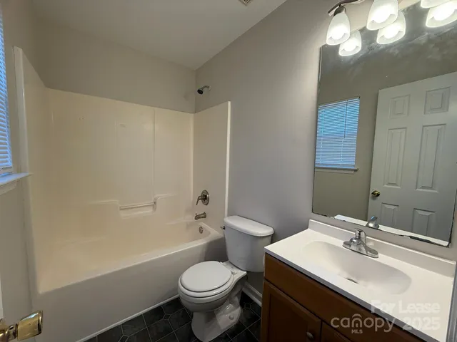 a bathroom with a sink toilet vanity and shower