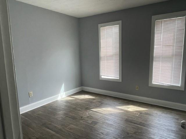6721 Trafalger Square Norcross, GA 30093 - Photo 12 of 13 an empty room with wooden floor and windows