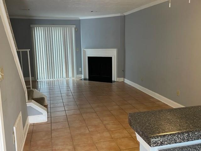 6721 Trafalger Square Norcross, GA 30093 - Photo 6 of 13 an empty room with a fireplace and a rug