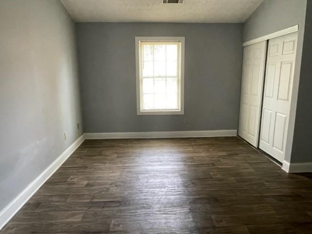 6721 Trafalger Square Norcross, GA 30093 - Photo 10 of 13 an empty room with wooden floor and windows