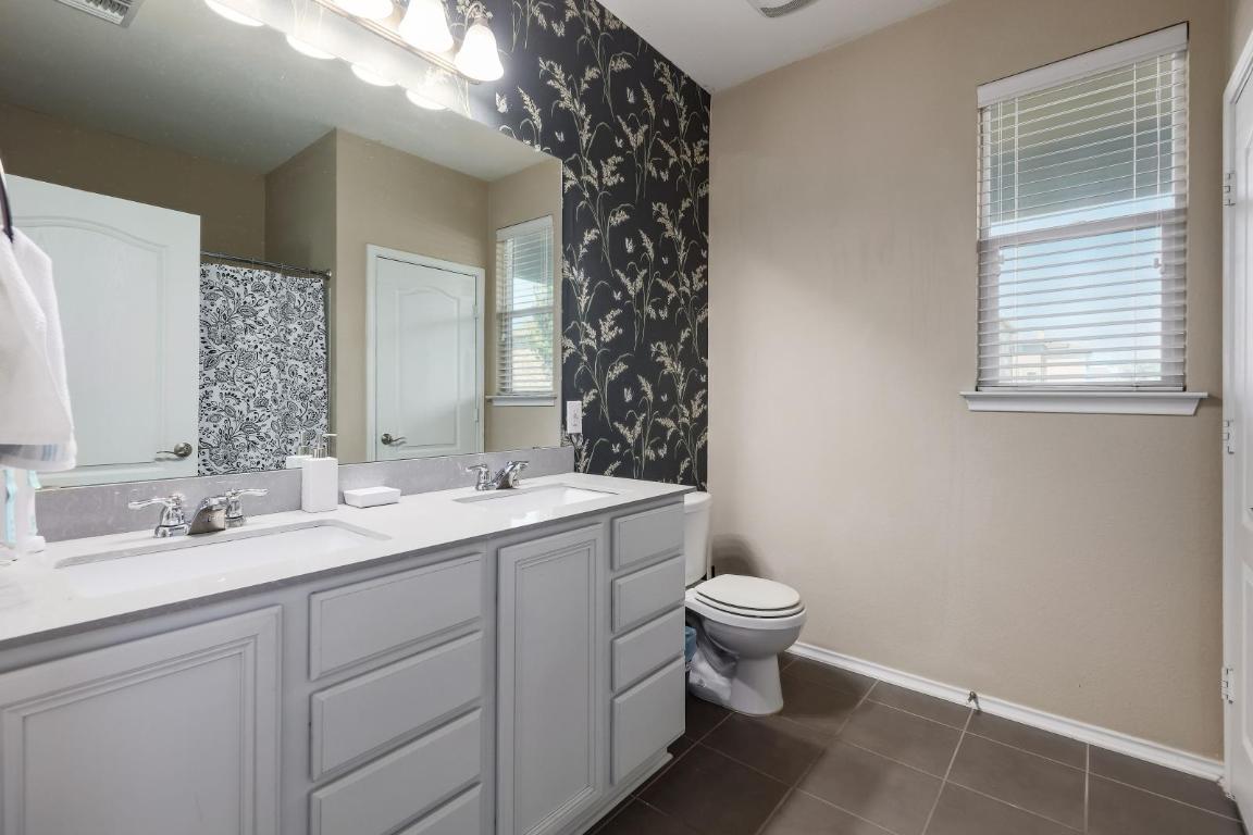 6300 Garden Rose Path Austin, TX 78754 - Photo 16 of 25 a bathroom with a double vanity sink and a mirror