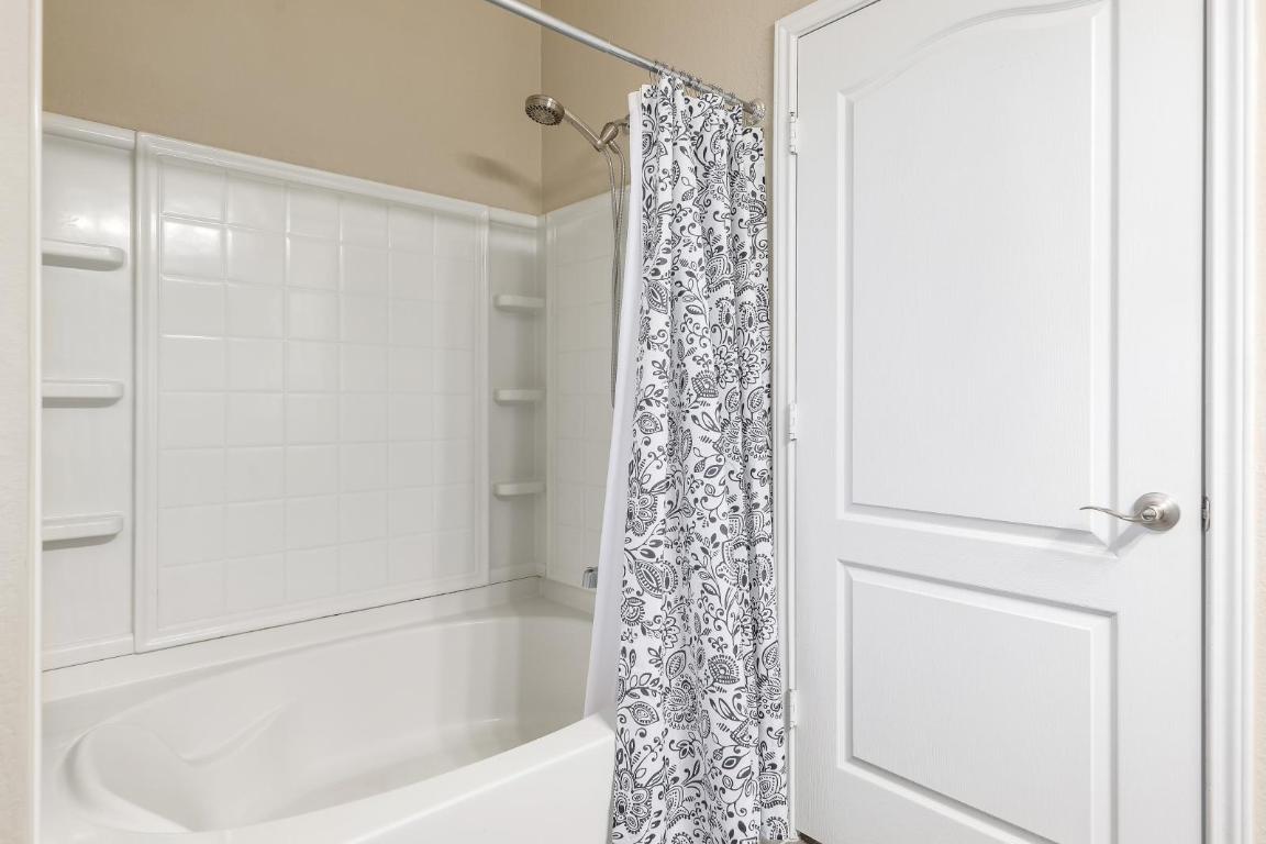 6300 Garden Rose Path Austin, TX 78754 - Photo 17 of 25 a bathroom with a bathtub and shower