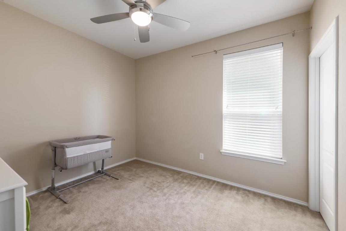 6300 Garden Rose Path Austin, TX 78754 - Photo 18 of 25 a room with a window and a ceiling fan