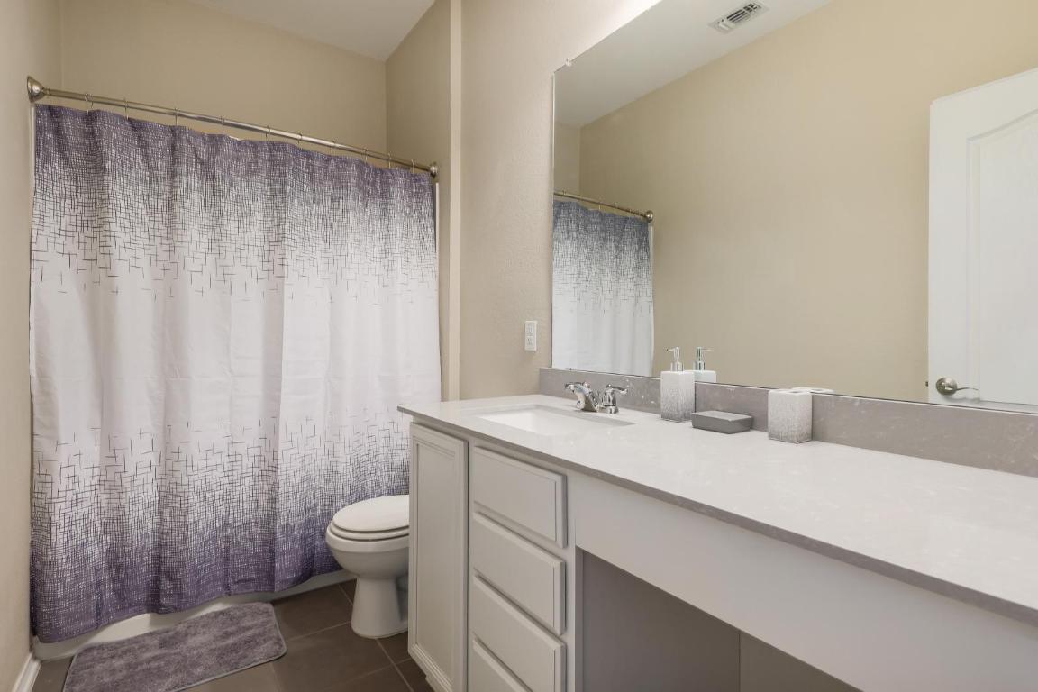 6300 Garden Rose Path Austin, TX 78754 - Photo 20 of 25 a bathroom with a granite countertop sink and a toilet