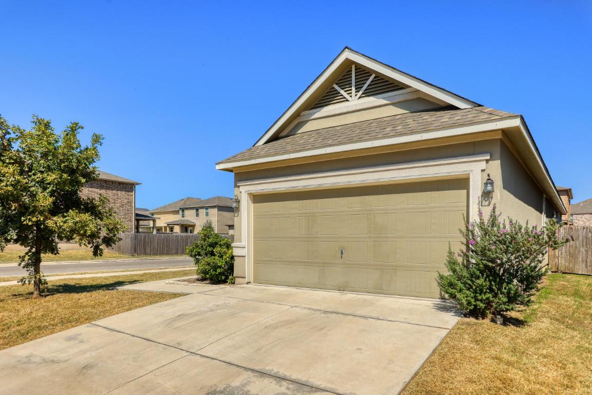 6300 Garden Rose Path Austin, TX 78754 - Photo 3 of 25 a front view of a house with a yard and garage