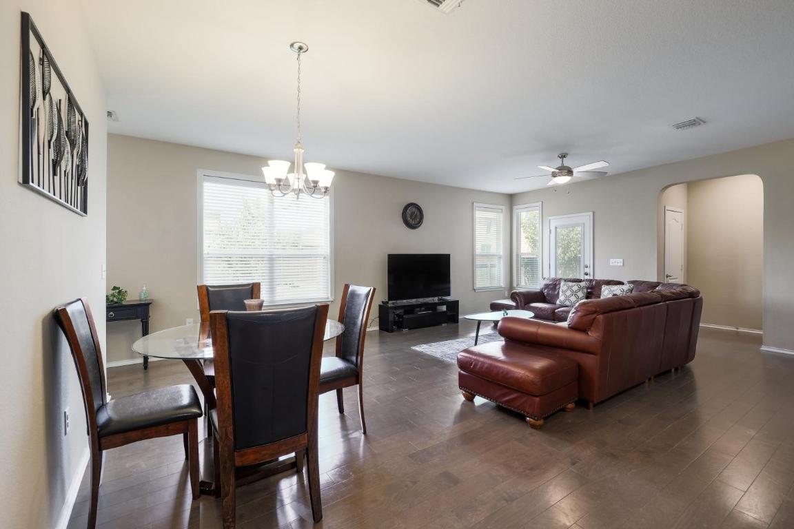 6300 Garden Rose Path Austin, TX 78754 - Photo 9 of 25 a living room with furniture a window and a flat screen tv