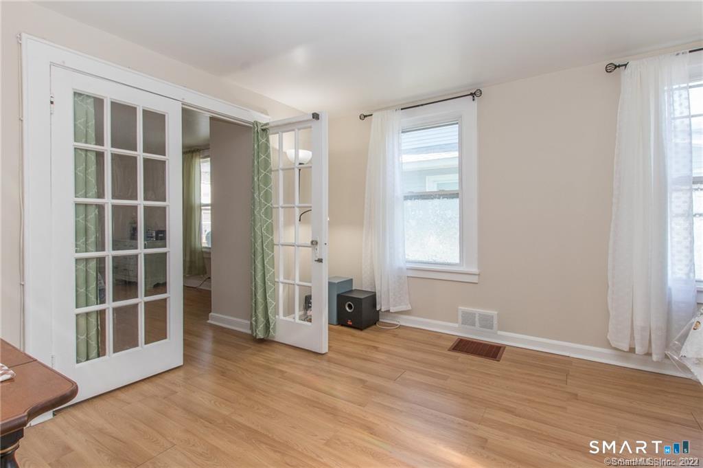 18 Lawrence Street Norwalk, CT 06854 - Photo 13 of 31 an empty room with wooden floor and windows