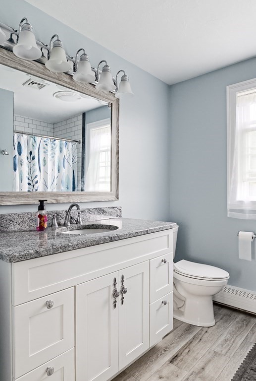 22 Vista Circle Rutland, MA 01543 - Photo 20 of 39 a bathroom with a granite countertop toilet a sink and a window