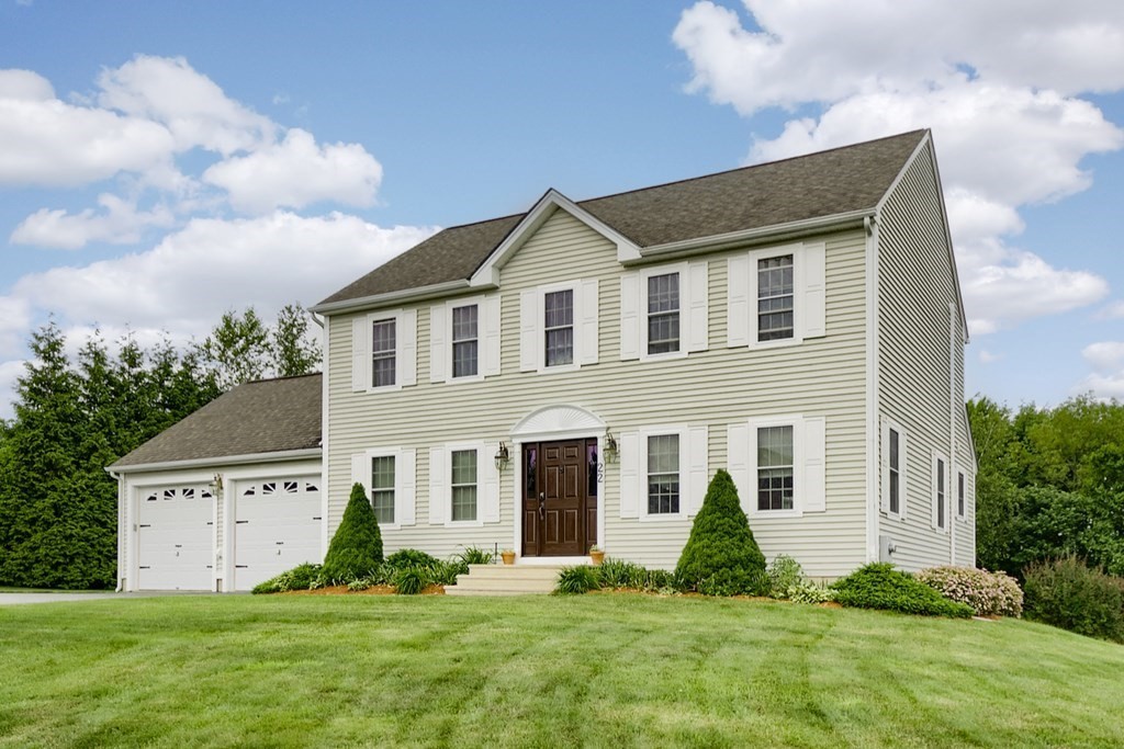 22 Vista Circle Rutland, MA 01543 - Photo 2 of 39 a front view of a house with a yard and garage