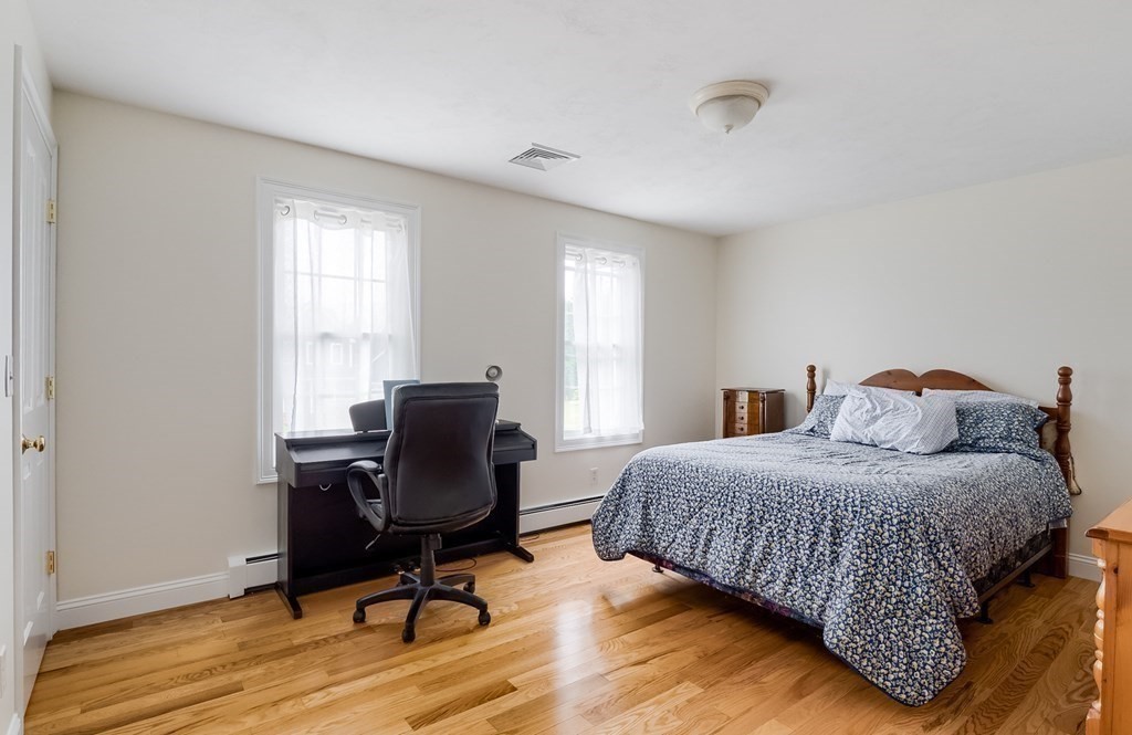 22 Vista Circle Rutland, MA 01543 - Photo 24 of 39 a bedroom with a bed a chair and a window
