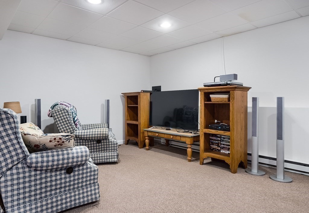 22 Vista Circle Rutland, MA 01543 - Photo 30 of 39 a living room with furniture gym equipment and a flat screen tv