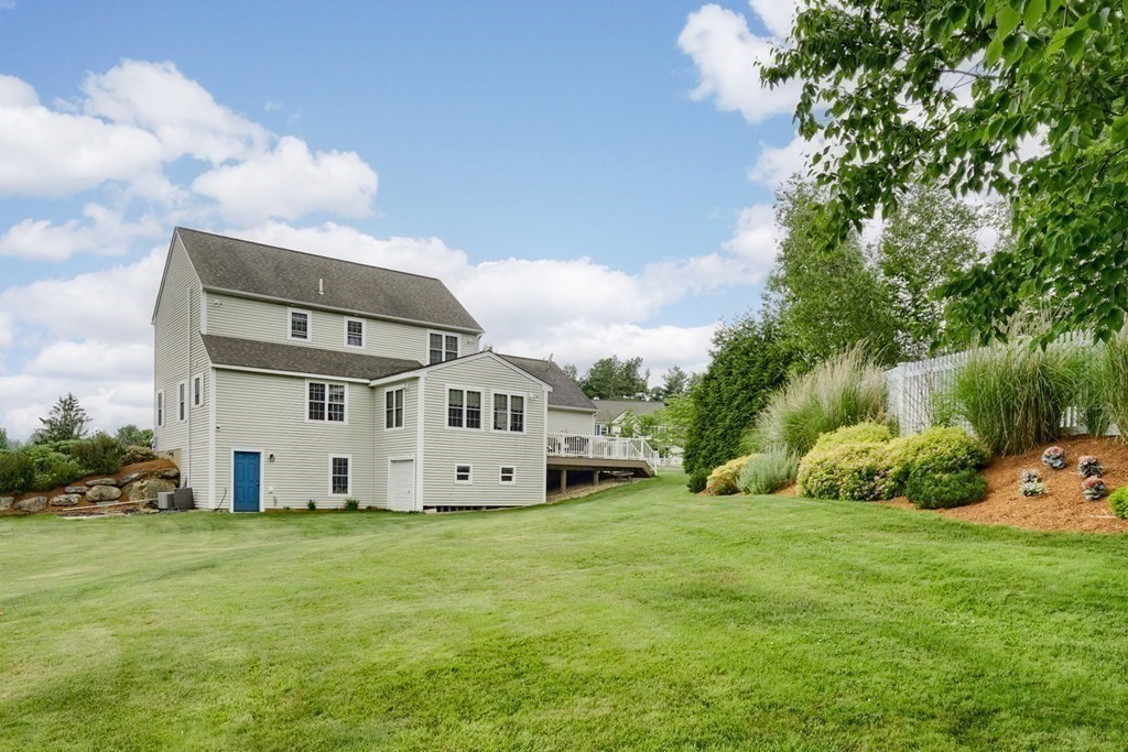 22 Vista Circle Rutland, MA 01543 - Photo 38 of 39 a white house with a big yard and large trees