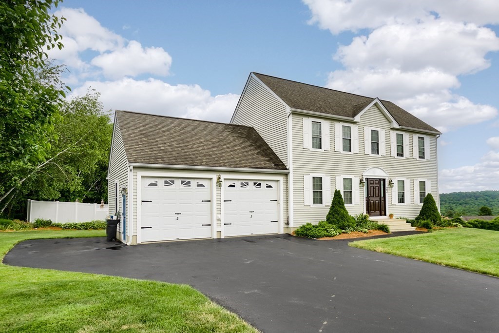 22 Vista Circle Rutland, MA 01543 - Photo 39 of 39 a front view of a house with a yard and garage