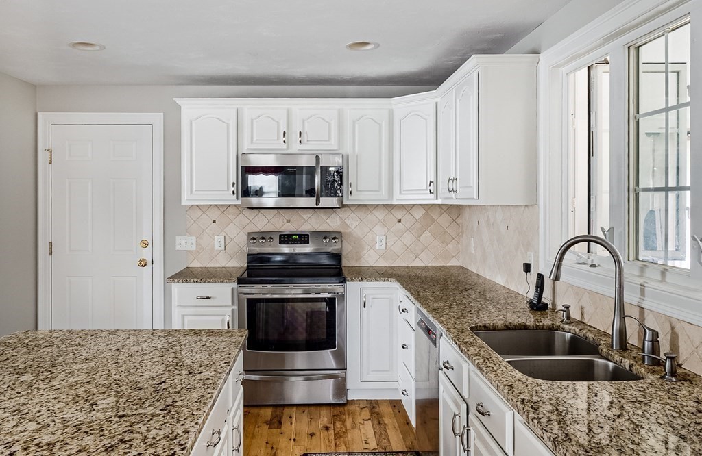 22 Vista Circle Rutland, MA 01543 - Photo 4 of 39 a kitchen with stainless steel appliances granite countertop a sink stove and cabinets