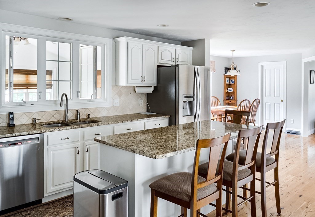 22 Vista Circle Rutland, MA 01543 - Photo 5 of 39 a kitchen with stainless steel appliances granite countertop a stove a sink dishwasher a dining table and chairs