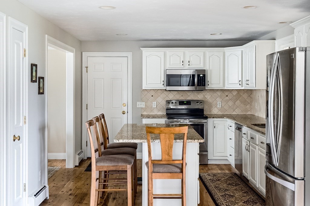 22 Vista Circle Rutland, MA 01543 - Photo 6 of 39 a kitchen with stainless steel appliances a stove a sink and a refrigerator