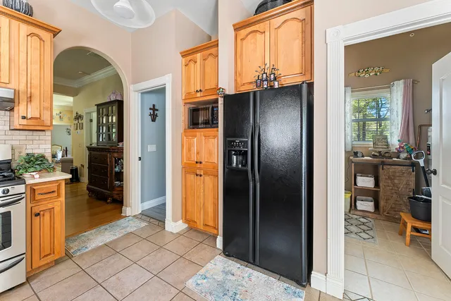 a kitchen with stainless steel appliances granite countertop a refrigerator and a sink