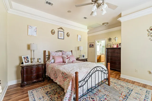 a bedroom with a bed and a chandelier