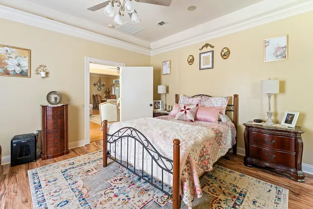 a bedroom with a bed and a chandelier