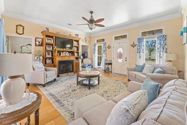 a living room with furniture a rug and a window