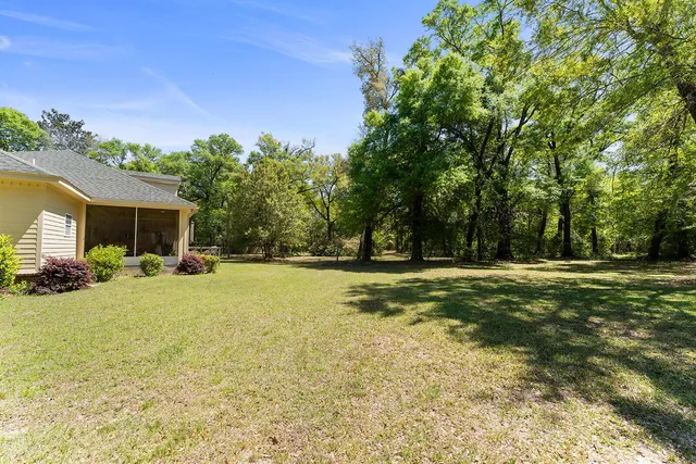 a view of a house with backyard and sitting area