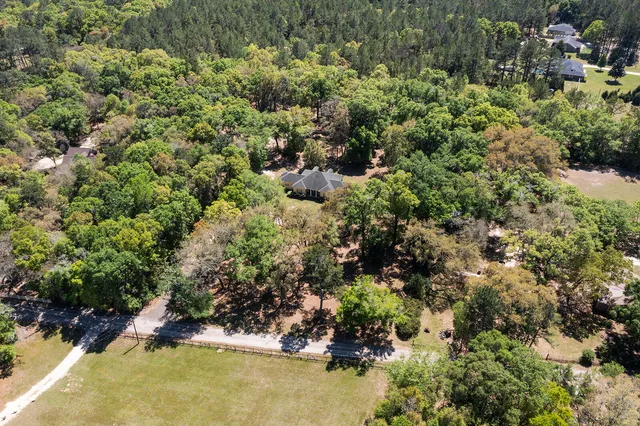 an aerial view of residential houses with yard and swimming pool