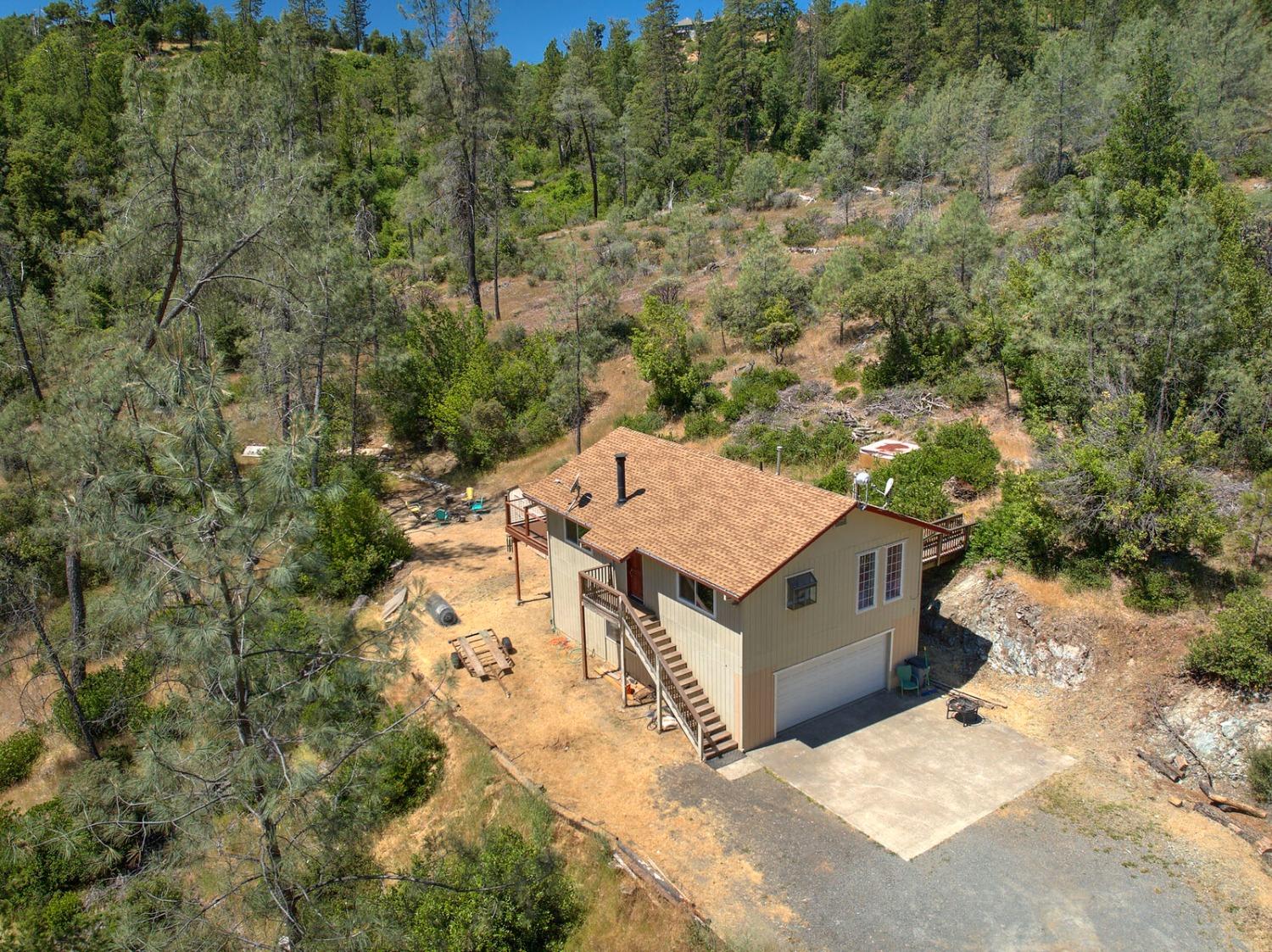 an aerial view of a house with a yard