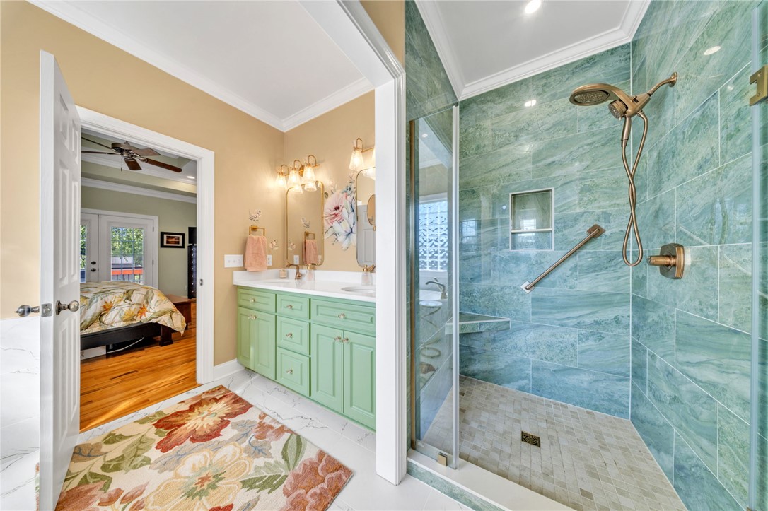 648 Mountain View Road Williamston, SC 29697 - Photo 19 of 42 Discover a tranquil primary bathroom boasting a double vanity and a glass-enclosed shower.