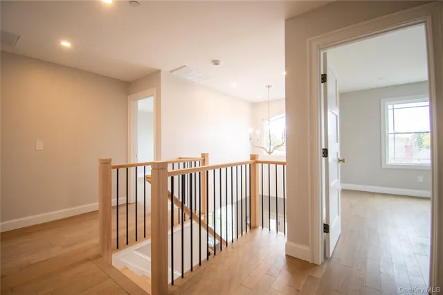 a view of entryway and hall with wooden floor